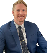 a smiling man in a blue suit and tie